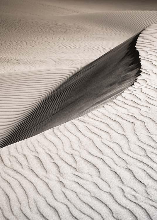 –Fotografi av ett sanddynlandskap.