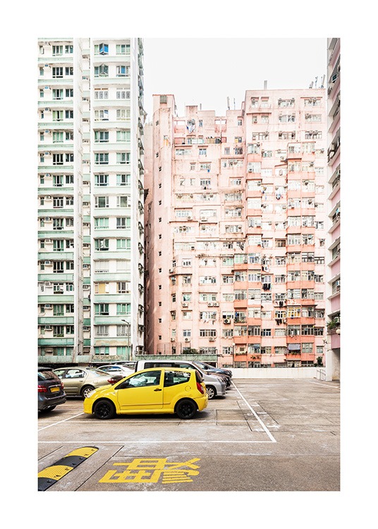 - Foto från Hong Kong med en gul bil framför pastellfärgade flerbostadshus i grönt och rosa